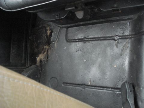 1977 Jeep Cherokee - Accumulated dirt and debris in the interior floor area of a vehicle.