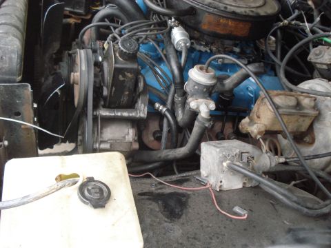 1977 Jeep Cherokee - Close-up view of a vehicle's engine bay, showing various components and wiring. The Supermotors.net logo is present in the lower right corn…