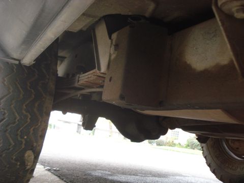 1977 Jeep Cherokee - A low-angle shot reveals the undercarriage components, including leaf springs and a differential, with a visible watermark.