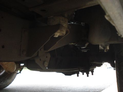 1977 Jeep Cherokee - Underside view of vehicle frame and suspension parts, showing drivetrain components.