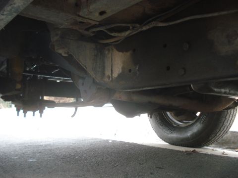 1977 Jeep Cherokee - Underside view of a vehicle's frame and suspension components, including leaf springs and a tire. The registry claims it is a 1977 Jeep Che…