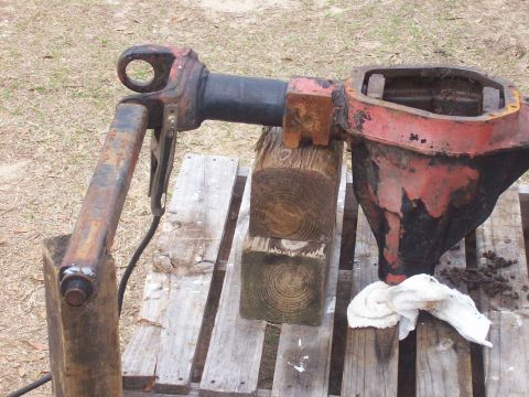 1982 Ford F-100 - A disassembled differential axle housing and driveshaft assembly rests on wooden blocks and a pallet.