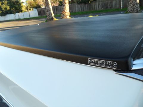 1973 Ford Ranchero - A white vehicle's bed is covered by a black Protect-O-Top cover.