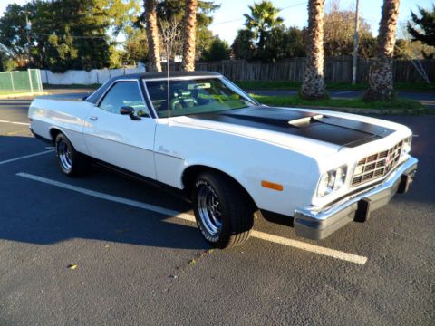 1973 Ford Ranchero - This 1973 Ford Ranchero features a two-tone paint scheme with a black hood scoop and vinyl top.