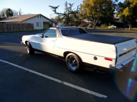 1973 Ford Ranchero - This 1973 Ford Ranchero is captured from a rear three-quarter view, highlighting its white body and black bed cover.