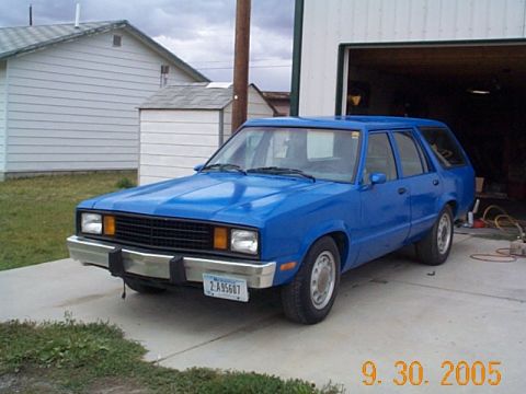 1982 Mercury Zephyr - A blue 1982 Mercury Zephyr station wagon is parked on a driveway in front of an open garage.