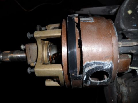 1973 Ford Ranchero - Close-up view of a steering column assembly, showing a brass bracket and a brown housing with visible wear.