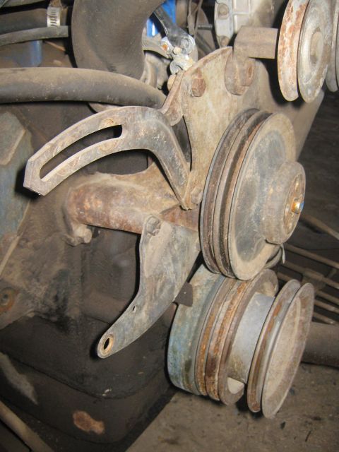 1972 Ford F-250 - Close-up of an engine's accessory bracket and pulleys, showing signs of age and use.