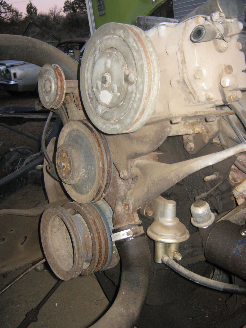 Close-up of engine pulleys and fuel pump assembly