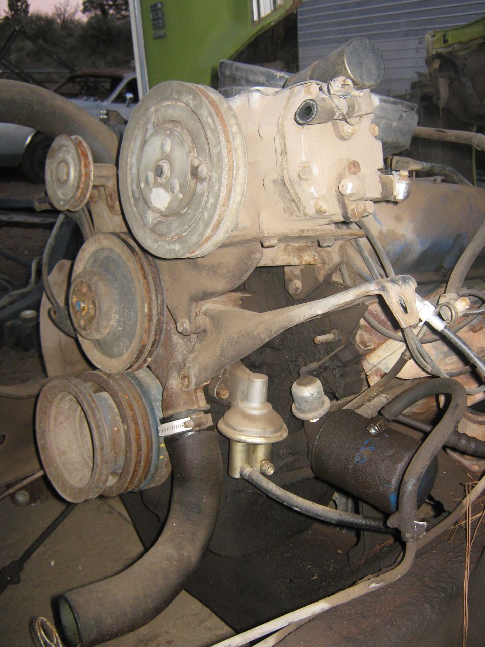 Engine motor with multiple pulleys, hoses, and a fuel pump