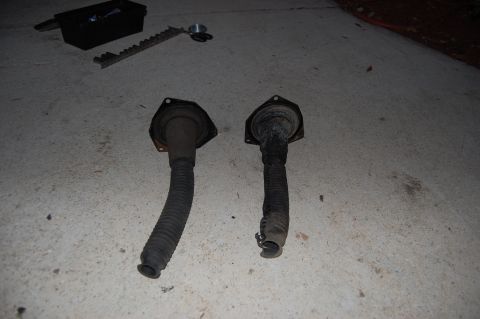 1994 Ford Bronco - Two rubber bellows with mounting flanges are shown on a concrete surface.