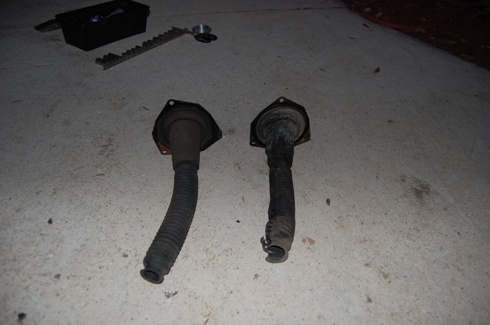 Two rubber bellows with mounting flanges, one intact, one damaged