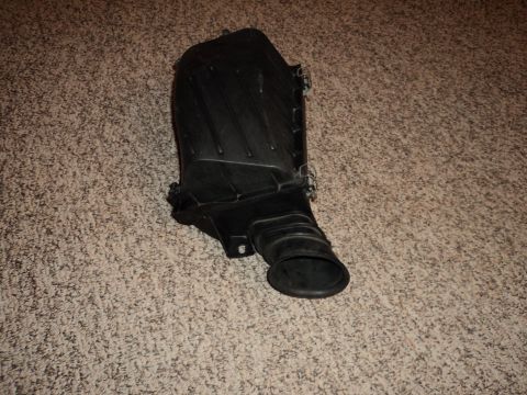 2004 Mercury Grand Marquis - Air intake box part shown on carpet.