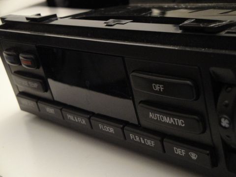 1993 Ford Taurus - Close-up of a car's climate control panel showing various function buttons.