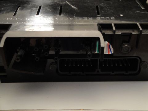1993 Ford Taurus - Close-up of electrical connectors on an automotive instrument cluster, with text indicating bulb replacement.