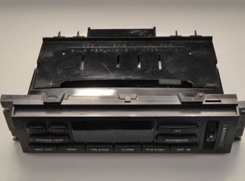 1993 Ford Taurus - This is a close-up of a car's climate control unit, showing various function buttons and a temperature slider.