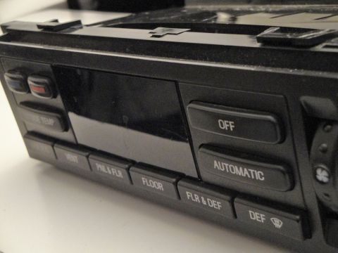 1993 Ford Taurus - Close-up of a car's climate control panel showing various function buttons.