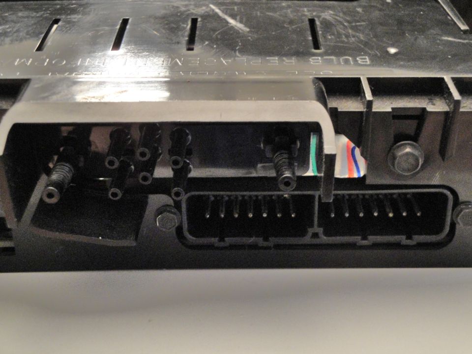 Close-up of electrical connectors and wiring harness with text 'BULB REPLACEMENT INFO'
