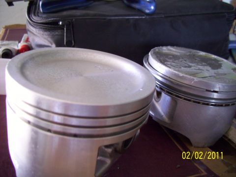 1995 Ford Probe - Close-up view of two engine pistons, likely for a performance build.
