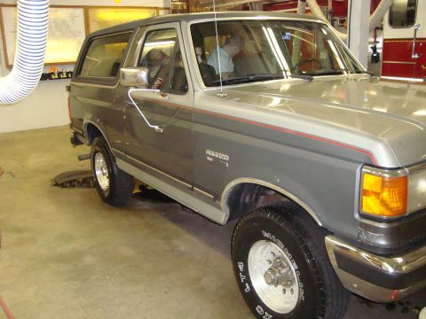 1991 Ford Bronco - A 1991 Ford Bronco is shown in a garage with a person inside the driver's seat.