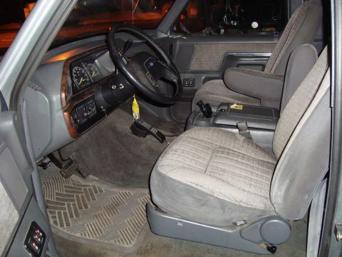 1991 Ford Bronco - The interior of a 1991 Ford Bronco shows its gray seats, dashboard, and floor mats.