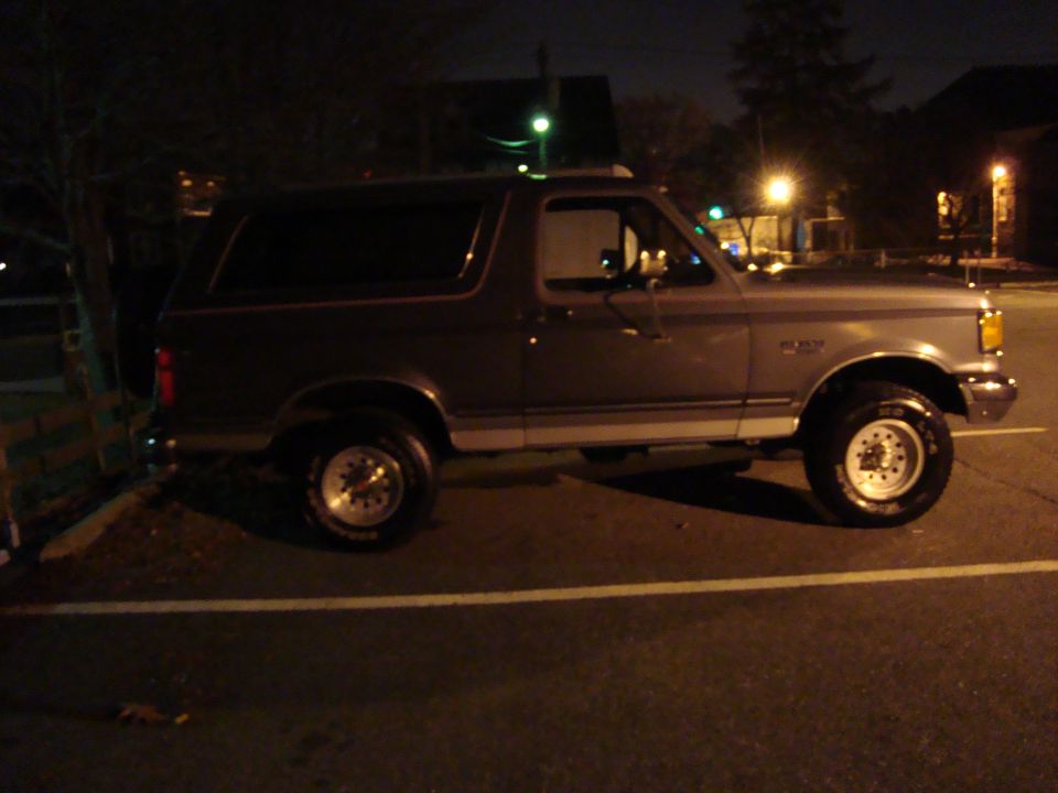 Side view of a 1991 Ford Bronco parked at night