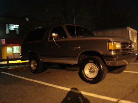 1991 Ford Bronco - A 1991 Ford Bronco is seen parked at night in a lot.