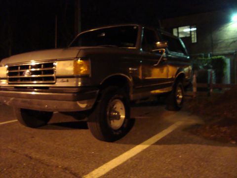 1991 Ford Bronco - 1991 Ford Bronco parked in a lot after dark.