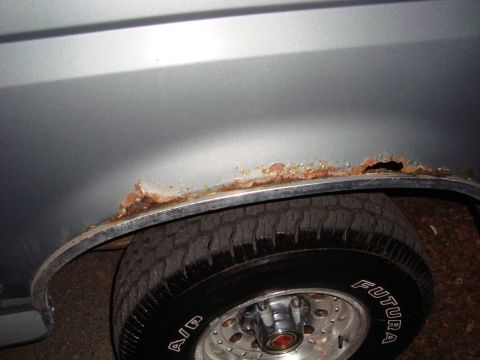 1991 Ford Bronco - This vehicle has significant rust damage around the wheel well, indicating poor maintenance or age.