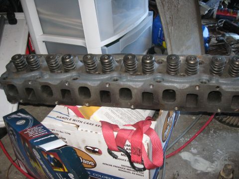 1981 Ford Bronco - A close-up view of an engine cylinder head with visible valve springs and ports.