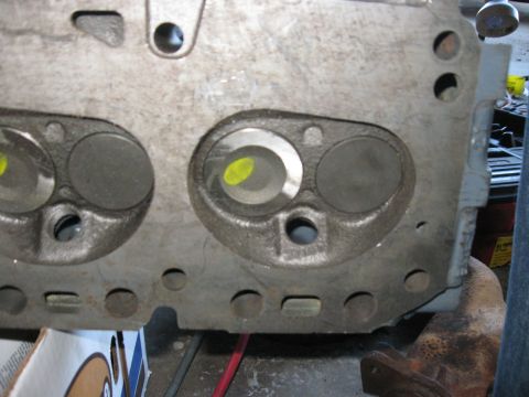 1981 Ford Bronco - Close-up of an engine cylinder head, showing valve openings and mounting holes.