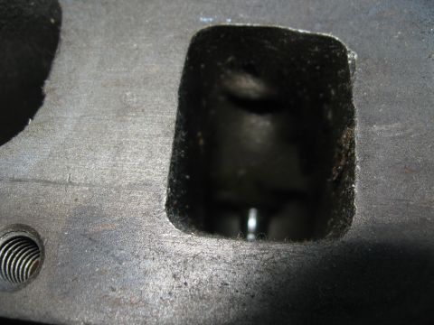 1981 Ford Bronco - This is a close-up view of a metal engine part, likely a cylinder head, showing an intake or exhaust port.