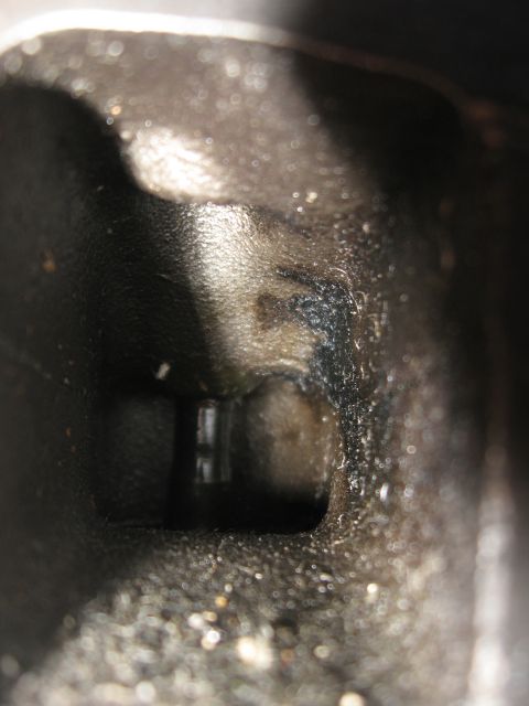 1981 Ford Bronco - Close-up view inside an engine cylinder head, revealing the valve seat area.
