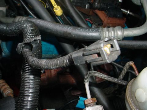 1993 Ford Bronco - Close-up view of engine components including a Goodyear Galaxy hose and an electrical connector.