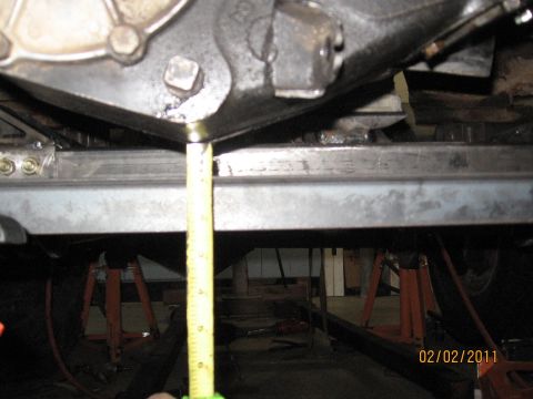 1961 International Scout 800 - Measuring undercarriage crossmembers with a tape measure.