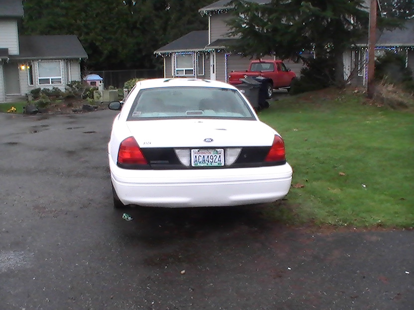 White 2003 Ford Crown Victoria sedan, rear view, Washington license plate ACA4924