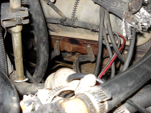 1993 Ford C-150 (Centurion Conversions) - Close-up view of an engine compartment, focusing on the exhaust manifold and associated components.