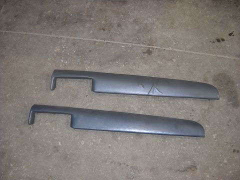 1993 Ford C-150 (Centurion Conversions) - Two dark gray interior trim pieces are shown lying on a concrete surface. The upper piece has a subtle etched design.