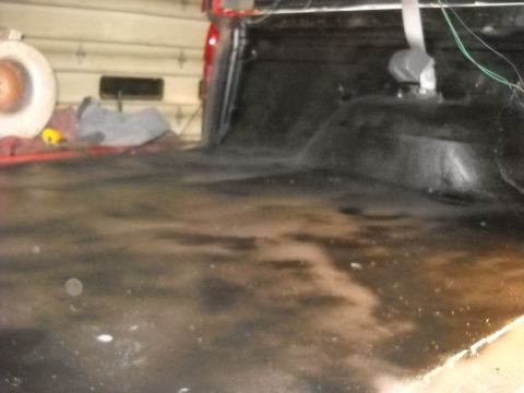 1993 Ford C-150 (Centurion Conversions) - View inside a truck bed, showing the floor and wheel well area.