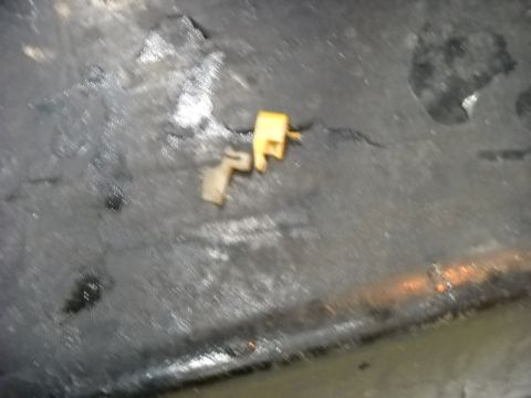 1993 Ford C-150 (Centurion Conversions) - Close-up view of two small plastic door lock actuators, one tan and one yellow.