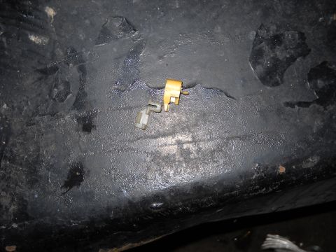 1993 Ford C-150 (Centurion Conversions) - A small door lock actuator component is shown against a dark, textured background.