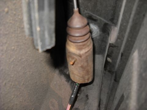 1993 Ford C-150 (Centurion Conversions) - This is a close-up view of a vehicle's door lock actuator rod, showing signs of rust and wear.