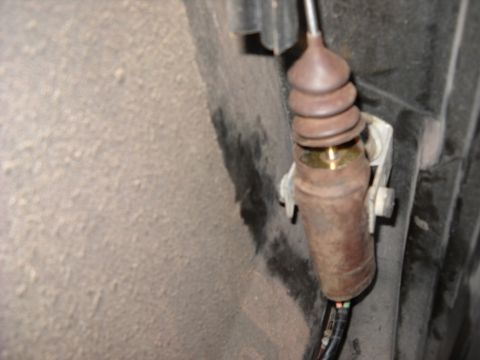 1993 Ford C-150 (Centurion Conversions) - Door lock actuator cable assembly, showing wear and corrosion on the metal components.