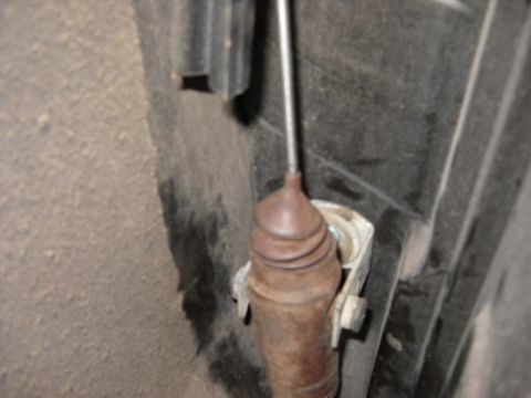 1993 Ford C-150 (Centurion Conversions) - Close-up view of a vehicle's clutch slave cylinder, showing its weathered condition.
