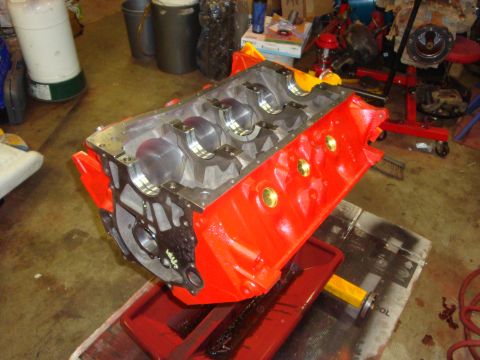 1989 Ford Bronco - Engine block on a stand in a garage setting, with tools and parts in the background.