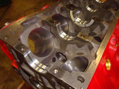 1989 Ford Bronco - Close-up view of an engine block, likely undergoing a rebuild, showing internal components and machined surfaces.