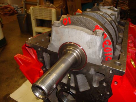 1989 Ford Bronco - Close-up view of an engine block assembly, showing the crankshaft and bearing caps with red markings.
