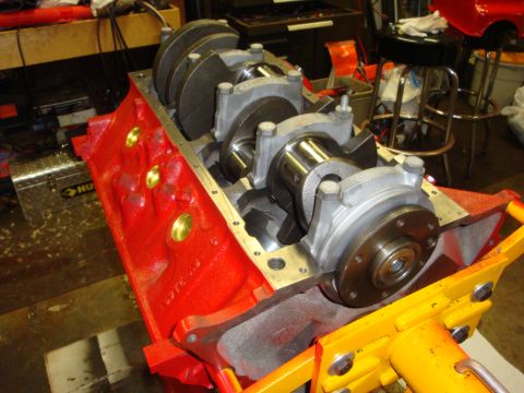 1989 Ford Bronco - Engine block and crankshaft assembly on an engine stand in a workshop.