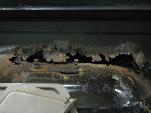 1993 Ford Bronco - Significant rust damage is visible on this vehicle's frame, with two bolts securing a metal plate.