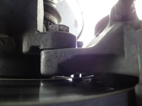 1993 Ford Taurus - This image shows a close-up view of a vehicle's brake system components, specifically the caliper and rotor.
